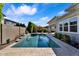 A stunning backyard pool featuring a tranquil waterfall and lush landscaping for added privacy at 3648 E Arabian Dr, Gilbert, AZ 85296
