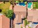 Stunning aerial view of home with backyard pools, mature trees and lush landscaping at 3841 E Redfield Ct, Gilbert, AZ 85234