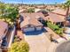 Aerial view of home showing tile roof, desert landscaping, three car garage, and palm trees at 3841 E Redfield Ct, Gilbert, AZ 85234