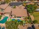 Expansive aerial view of property featuring dual pools, mature trees, and outdoor enjoyment at 3841 E Redfield Ct, Gilbert, AZ 85234