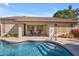Beautiful backyard with a pool, covered patio, desert landscaping, and outdoor dining area at 3841 E Redfield Ct, Gilbert, AZ 85234