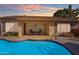 Backyard patio includes a pool, covered dining area, desert landscaping, and a staircase into the pool at 3841 E Redfield Ct, Gilbert, AZ 85234