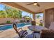 Inviting backyard patio with seating area, ceiling fan and pool views, perfect for entertaining at 3841 E Redfield Ct, Gilbert, AZ 85234