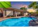 Lush backyard with a refreshing pool, desert landscaping, covered patio and stunning sky views at 3841 E Redfield Ct, Gilbert, AZ 85234