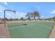 A community basketball court on a sunny day, surrounded by green space and trees at 3841 E Redfield Ct, Gilbert, AZ 85234