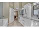 Bathroom with a large vanity with double sinks, a white cabinet, and quartz countertop at 3841 E Redfield Ct, Gilbert, AZ 85234