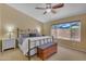 Inviting bedroom with a comfortable bed, ceiling fan, and a bright window with a view at 3841 E Redfield Ct, Gilbert, AZ 85234