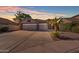 Charming single-story home showcasing a three-car garage and well-manicured landscaping and a beautiful sunset at 3841 E Redfield Ct, Gilbert, AZ 85234