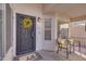 Cozy front porch with seating, a decorative wreath, and a 'hello' doormat at 3841 E Redfield Ct, Gilbert, AZ 85234