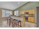 Open concept kitchen featuring stainless steel appliances, a breakfast bar with stool seating, and a dining area at 3841 E Redfield Ct, Gilbert, AZ 85234