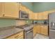 Modern kitchen boasting stainless steel oven, granite countertops, and light wood cabinets at 3841 E Redfield Ct, Gilbert, AZ 85234