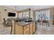 Kitchen island with granite countertop, sink, and breakfast bar seating adjacent to a dining table at 3841 E Redfield Ct, Gilbert, AZ 85234