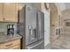 Kitchen features stainless steel refrigerator with water dispenser and granite countertops at 3841 E Redfield Ct, Gilbert, AZ 85234