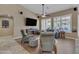 Bright living room featuring comfortable seating, a ceiling fan, and large windows with plantation shutters at 3841 E Redfield Ct, Gilbert, AZ 85234