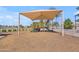 Community playground with covered play structure and wood chip ground cover on a sunny day at 3841 E Redfield Ct, Gilbert, AZ 85234