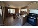 Open kitchen/dining area featuring tile floors, neutral paint and peninsula breakfast bar at 3937 W Stella Ln, Phoenix, AZ 85019