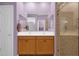 Bright bathroom featuring double sinks, vanity, and a glass-enclosed shower at 4027 W Copperleaf Dr, San Tan Valley, AZ 85144