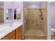 Bathroom with a double sink vanity, a large mirror, and a glass shower enclosure at 4027 W Copperleaf Dr, San Tan Valley, AZ 85144