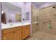 Bathroom with a double sink vanity, a large mirror, and a glass shower enclosure at 4027 W Copperleaf Dr, San Tan Valley, AZ 85144