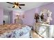 Bright bedroom featuring floral accents, decorative furnishings, and ceiling fan at 4027 W Copperleaf Dr, San Tan Valley, AZ 85144