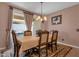 Cozy dining room featuring table set for six and sliding door to outdoor patio at 4027 W Copperleaf Dr, San Tan Valley, AZ 85144
