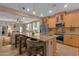 Open kitchen view with granite island, stainless appliances, and open access to living room at 4027 W Copperleaf Dr, San Tan Valley, AZ 85144