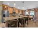 Open kitchen view with granite island, stainless appliances, and dining area featuring a sliding glass door at 4027 W Copperleaf Dr, San Tan Valley, AZ 85144
