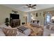 Inviting living room featuring comfortable seating, a large TV, and warm lighting fixtures at 4027 W Copperleaf Dr, San Tan Valley, AZ 85144