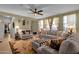 Comfortable living room featuring plush seating, ceiling fan, and elegant window treatments at 4027 W Copperleaf Dr, San Tan Valley, AZ 85144