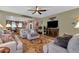 Cozy living room with open layout, tile floors, and seamless flow to the dining and kitchen areas at 4027 W Copperleaf Dr, San Tan Valley, AZ 85144
