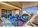 Inviting covered patio with comfortable seating, perfect for outdoor entertaining and relaxation at 4027 W Copperleaf Dr, San Tan Valley, AZ 85144