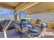 Inviting covered patio with comfortable seating, perfect for outdoor entertaining and relaxation at 4027 W Copperleaf Dr, San Tan Valley, AZ 85144