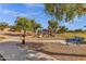 Playground with various play structures, benches, and nearby walking paths with mature trees at 4027 W Copperleaf Dr, San Tan Valley, AZ 85144