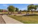 Community park featuring playground, benches, and walking paths within a lush green space at 4027 W Copperleaf Dr, San Tan Valley, AZ 85144