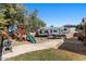 Spacious backyard featuring a playset, recreational vehicle parking, and mature trees offering ample shade at 421 E Terrace Ave, Gilbert, AZ 85234