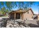 Back of home featuring covered patio, mature trees, and low-maintenance gravel landscaping at 421 E Terrace Ave, Gilbert, AZ 85234