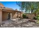 Backyard with covered patio, gravel landscaping, and shade trees, creating a peaceful outdoor space at 421 E Terrace Ave, Gilbert, AZ 85234