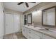 Bathroom featuring a double vanity with white cabinets, tile floor and a ceiling fan at 421 E Terrace Ave, Gilbert, AZ 85234