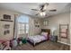 Cozy bedroom with a ceiling fan, window, and playful decor at 421 E Terrace Ave, Gilbert, AZ 85234
