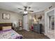 Charming bedroom featuring a ceiling fan, striped wall design, and neutral carpet at 421 E Terrace Ave, Gilbert, AZ 85234