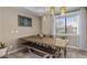 Dining room with wooden table and bench seating, hanging lights and view of the back yard through window at 421 E Terrace Ave, Gilbert, AZ 85234