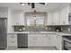 Charming kitchen featuring stainless steel appliances, white cabinets and tiled floors, with window view at 421 E Terrace Ave, Gilbert, AZ 85234