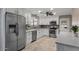 Stylish kitchen featuring stainless steel appliances, white cabinetry, neutral counter tops and tiled floors at 421 E Terrace Ave, Gilbert, AZ 85234