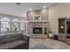 Inviting living room features stone fireplace, recessed lights, tiled floors and large windows with backyard view at 421 E Terrace Ave, Gilbert, AZ 85234