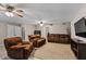 Cozy living room featuring plush brown seating, ceiling fans, and neutral decor, creating a relaxing atmosphere at 421 E Terrace Ave, Gilbert, AZ 85234