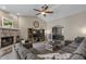 Cozy living room highlighting a stone fireplace, tile floors, and vaulted ceilings at 421 E Terrace Ave, Gilbert, AZ 85234