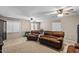 Large living room with brick accent wall, ceiling fans and tile floor at 421 E Terrace Ave, Gilbert, AZ 85234