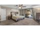 Cozy main bedroom with large bed, ceiling fan and sliding glass door to the back yard, with dresser at 421 E Terrace Ave, Gilbert, AZ 85234