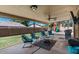 Inviting covered patio featuring comfortable seating, ceiling fans, and an outdoor play area, perfect for relaxation at 421 E Terrace Ave, Gilbert, AZ 85234