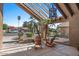Relaxing covered patio with chairs, swing and desert landscaping to enjoy the outdoors at 421 E Terrace Ave, Gilbert, AZ 85234